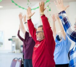 Older adults practice yoga at the Center for Active living in West Seattle.